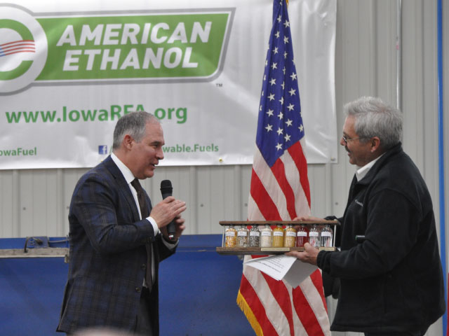 Iowa farmer, livestock producer and American Coalition for Ethanol member Bill Couser (right), presents EPA Administrator Scott Pruitt with a plaque showing the stages of ethanol production during at an event near Nevada, Iowa, on Friday. (DTN photo by Chris Clayton)